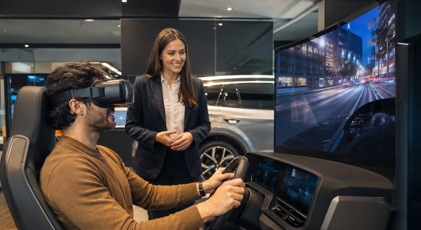 Customer trying a virtual test drive in an automotive showroom simulator